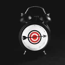 Black alarm clock with target on black background. related to Snuggle Up in Style: Explore the Ultimate Target Bedding Sets