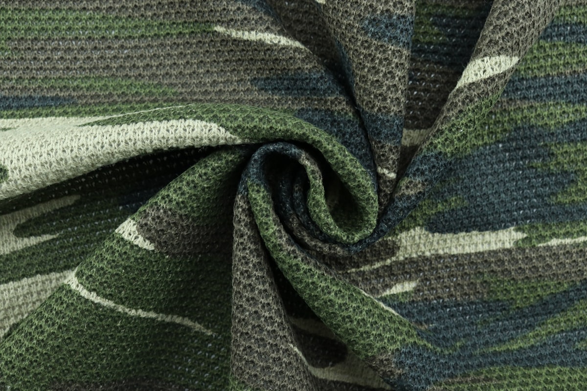 black and gray textile on white table related to Choosing the Perfect Camouflage Baby Bedding for Your Nursery