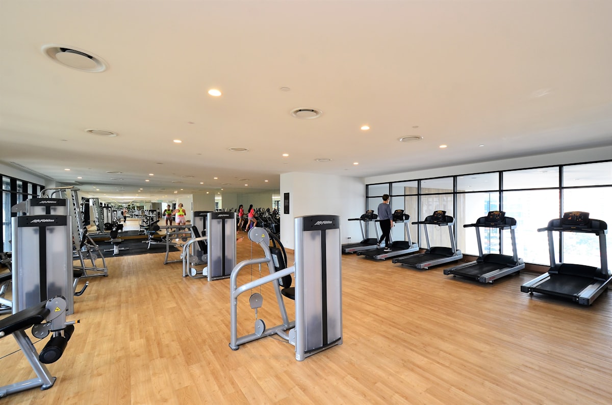 black and gray treadmill related to Find Your Perfect Match: Gyms with Tanning Beds Near You