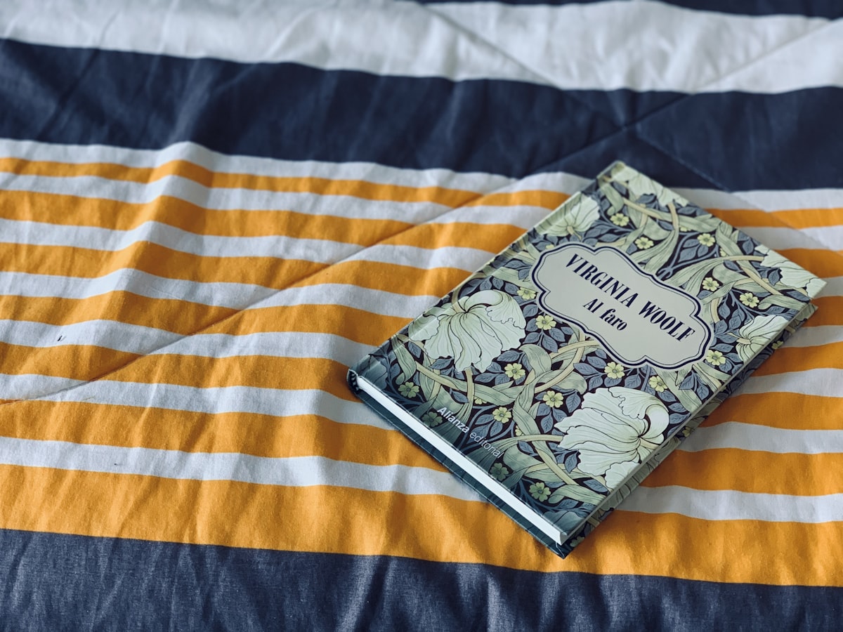 black and white book on white and brown textile related to What is a Matelasse Coverlet? A Comprehensive Guide