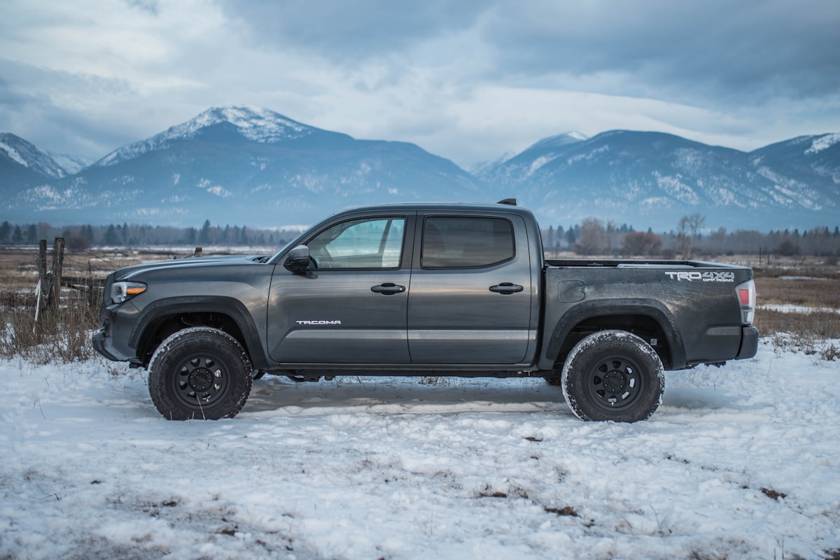 black crew cab pickup truck on snow covered ground during daytime related to Enhance Your Tacoma's Bed with the Perfect Mat
