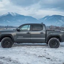 black crew cab pickup truck on snow covered ground during daytime related to Enhance Your Tacoma's Bed with the Perfect Mat