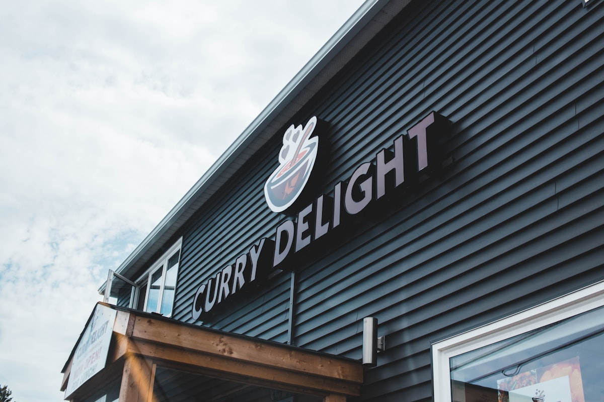 black Curry Delight signage related to Cozy Delights: Finding the Perfect Bed and Breakfast in OKC