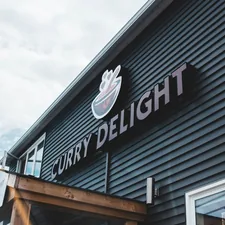 black Curry Delight signage related to Cozy Delights: Finding the Perfect Bed and Breakfast in OKC