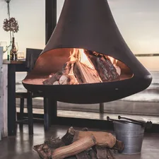 black firepit near dining set inside room related to Chiminea vs Fire Pit: Choosing the Perfect Outdoor Fireplace