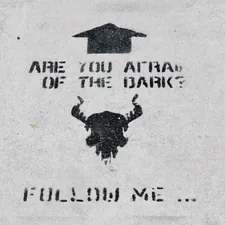 Black graffiti quote on the concrete   related to The Dark Side ofTan: Understanding the Risks of UVB Tanning Beds
