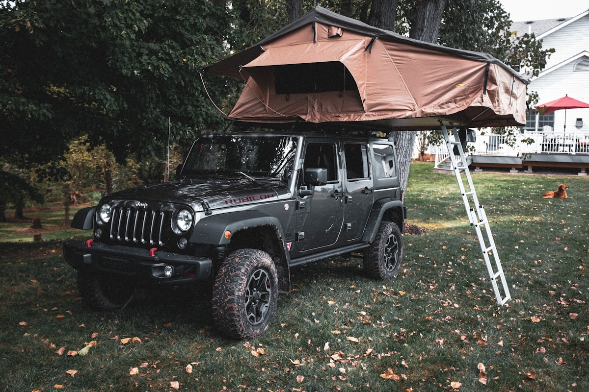 black jeep wrangler parked near brown wooden house during daytime related to Ultimate Guide to Jeep Bunk Beds