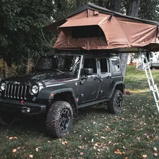 black jeep wrangler parked near brown wooden house during daytime related to Ultimate Guide to Jeep Bunk Beds