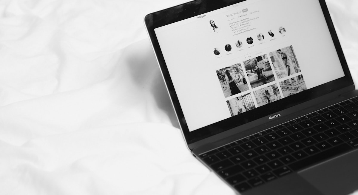 black laptop computer on white textile related to Elevating the Bed and Breakfast Experience Online