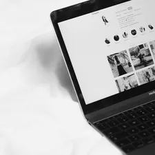 black laptop computer on white textile related to Elevating the Bed and Breakfast Experience Online