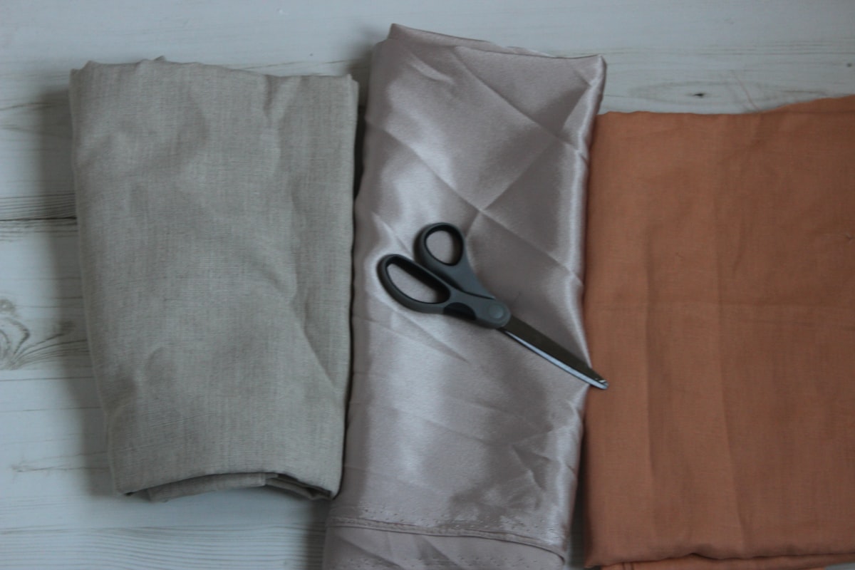 black scissors on gray textile related to How to Make a Scarf Valance