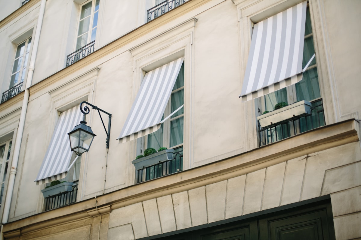 black sconce lamp on white concrete building related to Toile Window Valances
