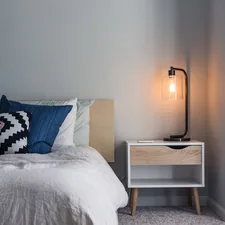 black table lamp on nightstand related to The Cozy World of Bed and Breakfasts