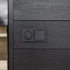 Black thermowood switches integrated into a textured wall, combining material depth with functional design. related to Dark Sideboard Furniture: Adding Depth and Drama to Your Home