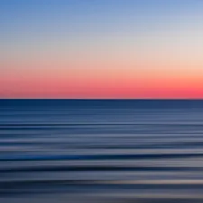 body of water during sunset related to Coastal Calm:  A Coral and Navy Bedroom Oasis
