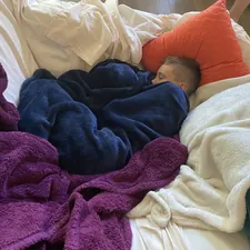 boy sleeping among blankets related to Exploring My Pillow at Bed Bath & Beyond: Comfort Redefined
