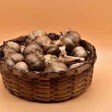 brown and white garlic on brown woven basket related to Understanding Tanning Bed Bulbs: Price Breakdown and Buying Guide