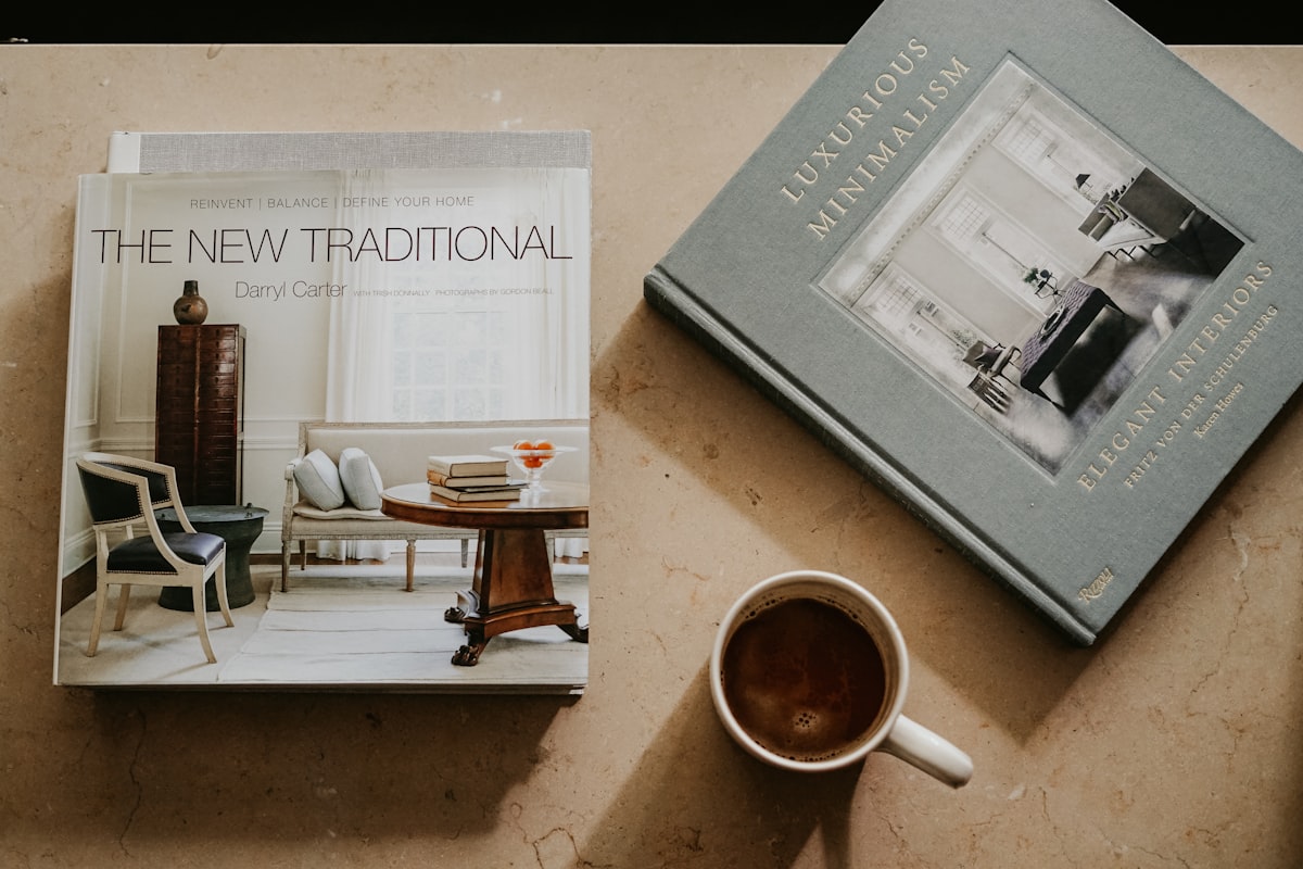 brown ceramic mug near two books related to Transforming Spaces: The Ultimate Guide to Amazon Kids Beds