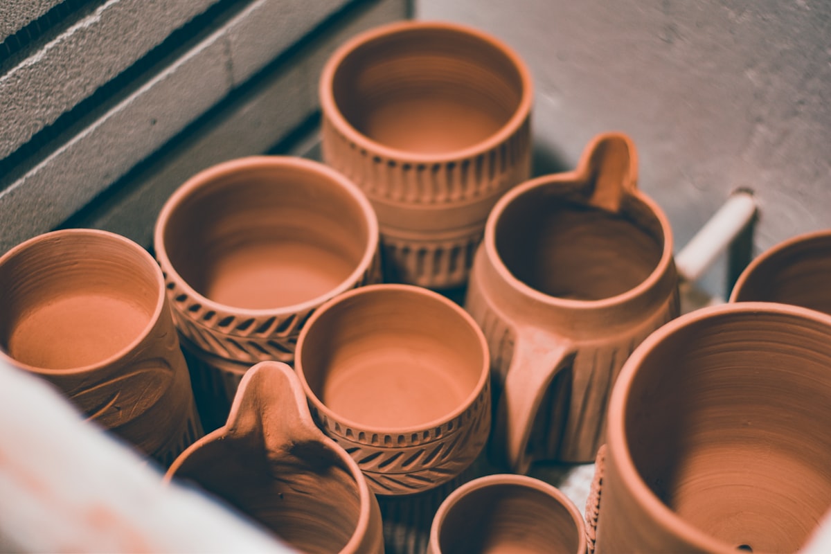 brown ceramic mugs on brown wooden shelf related to Where to Buy Clay Chiminea: A Comprehensive Guide