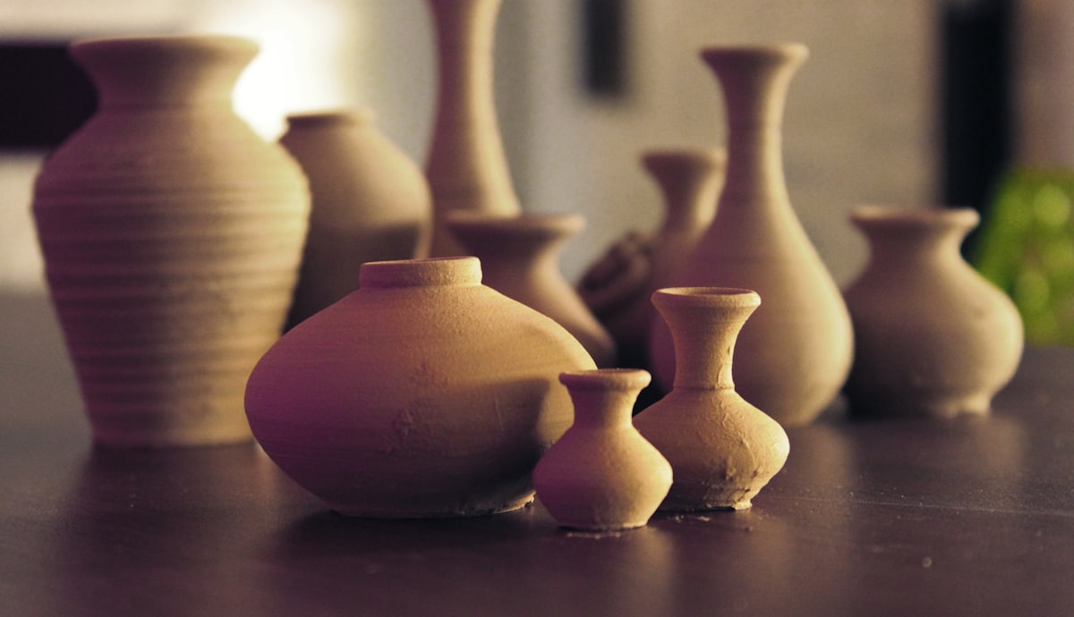 brown ceramic vases on wooden surface related to Ceramic Clay Chiminea for Sale