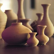 brown ceramic vases on wooden surface related to Ceramic Clay Chiminea for Sale