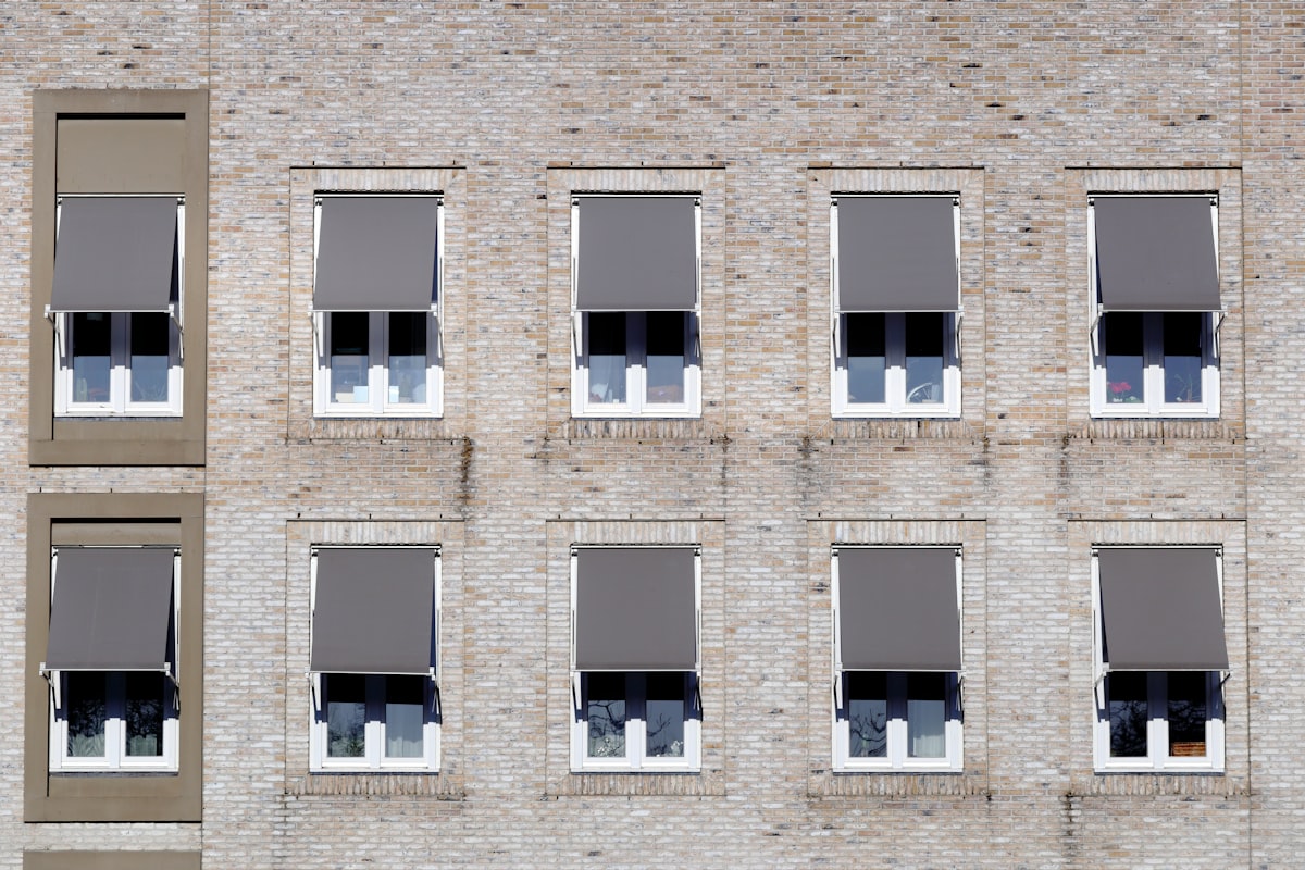 brown concrete building with glass windows related to Modern Window Valance Ideas