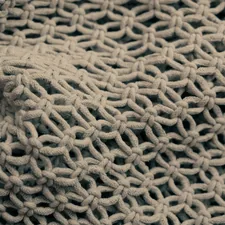 brown knit textile in close up photography related to Elevate Your Bedroom Décor with Handmade Elegance