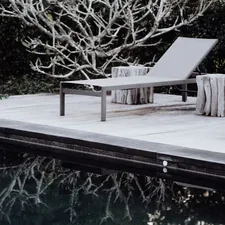 brown wooden bench near body of water during daytime related to Experience Bliss with a Chaise Lounge Bed
