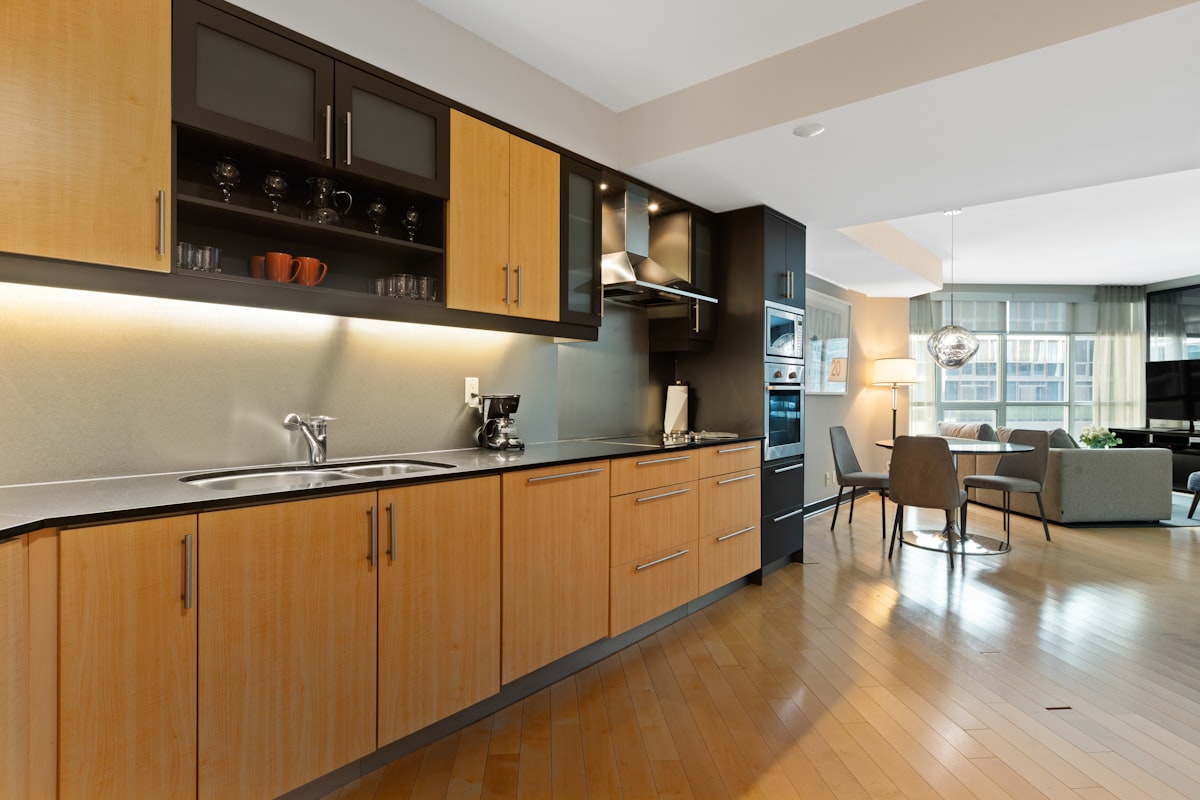 brown wooden kitchen cabinet and sink related to Enhancing Kitchen Design with Wood Valances over the Sink