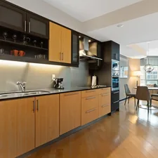 brown wooden kitchen cabinet and sink related to Enhancing Kitchen Design with Wood Valances over the Sink