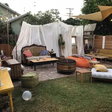 brown wooden table with chairs and white textile related to Revolutionizing Backyard Gatherings: The 360 Degree Chiminea