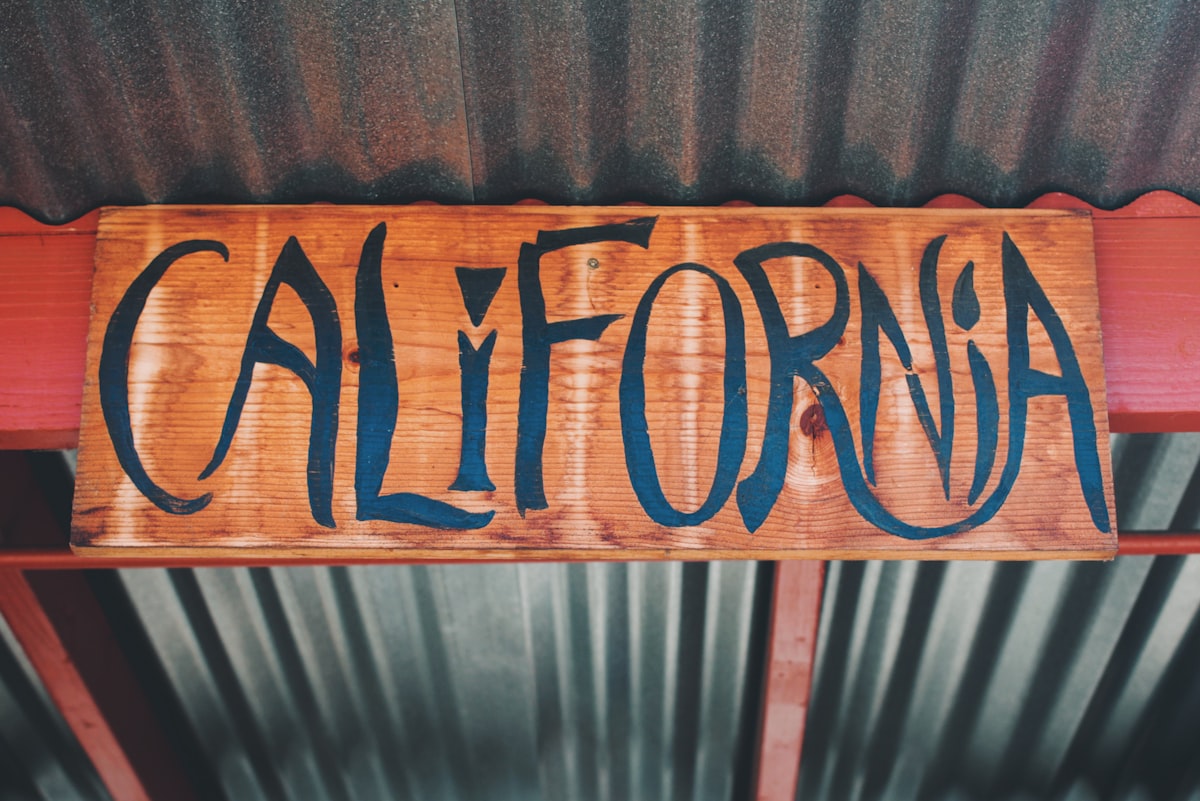 brown wooden welcome to the beach signage related to Slumbering in Style: A Guide to California King Bed Sheets