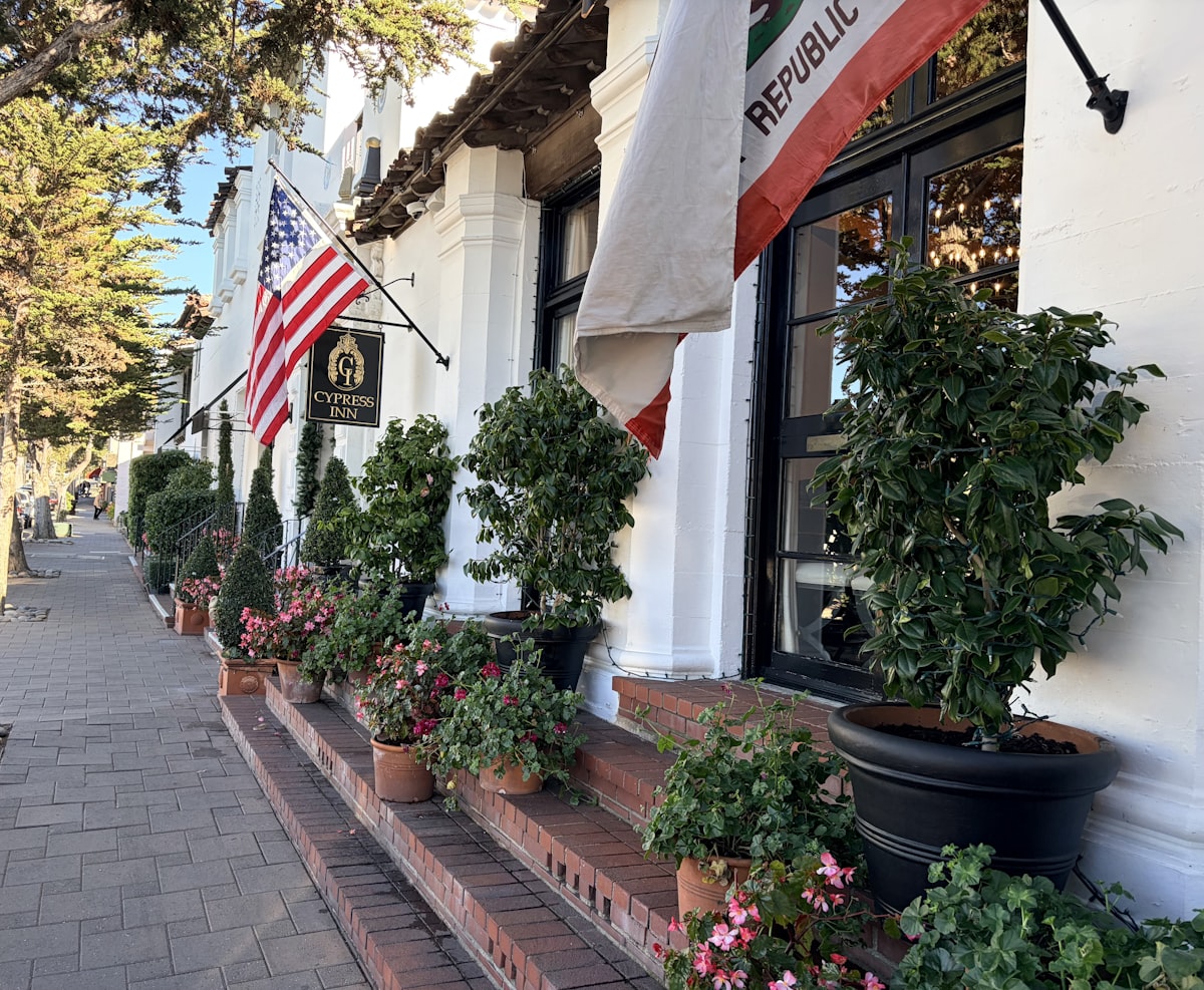 Building entrance with american and california flags. related to Elevating Your Home's First Impression: Mastering Entryway Flower Arrangement