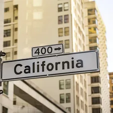 California street sign with buildings in background related to Understanding California King Bed Dimensions