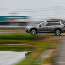 Car driving on the road. related to Exploring the Versatility of Subaru with a Truck Bed