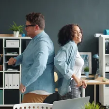 Caucasian man and Afro-American woman coworkers dancing in office, guy is falling being crazy. Happiness, relaxation and business concept. related to Maximizing Your Space with Overstock Bed Frames: A Smart Buy