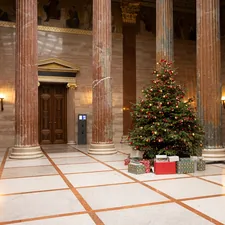 Christmas tree in the columned hall ("Säulenhalle") of the Austrian Parliament Building in Vienna. related to Welcome Home: Enhancing Your Entryway with a Hall Tree