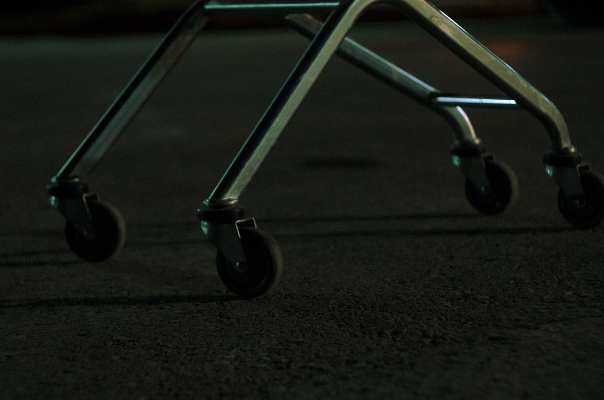 Close-up of a metal cart with four wheels related to The Ultimate Guide to Bed Frame Casters: Enhance Mobility and Style
