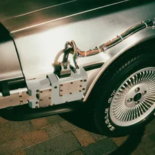 Close-up of a silver car's rear wheel and side panel related to Choosing the Right Hitch for Short Bed Trucks
