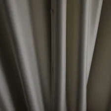 Close-up of textured gray fabric with vertical folds. related to Pinch Pleated Valances