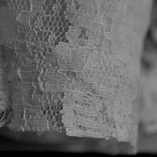 Close-up shot shows beautiful white lace fabric. related to Battenburg Lace Valances: A Comprehensive Guide