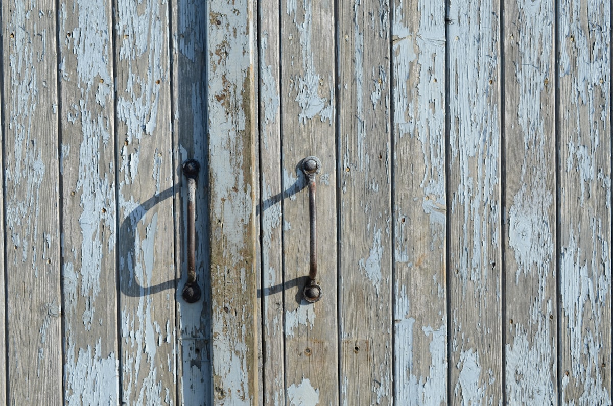 closed brown wooden door related to Reclaiming Elegance: The Charisma of Distressed Sideboards and Buffets