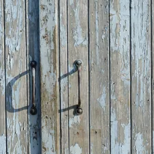 closed brown wooden door related to Reclaiming Elegance: The Charisma of Distressed Sideboards and Buffets