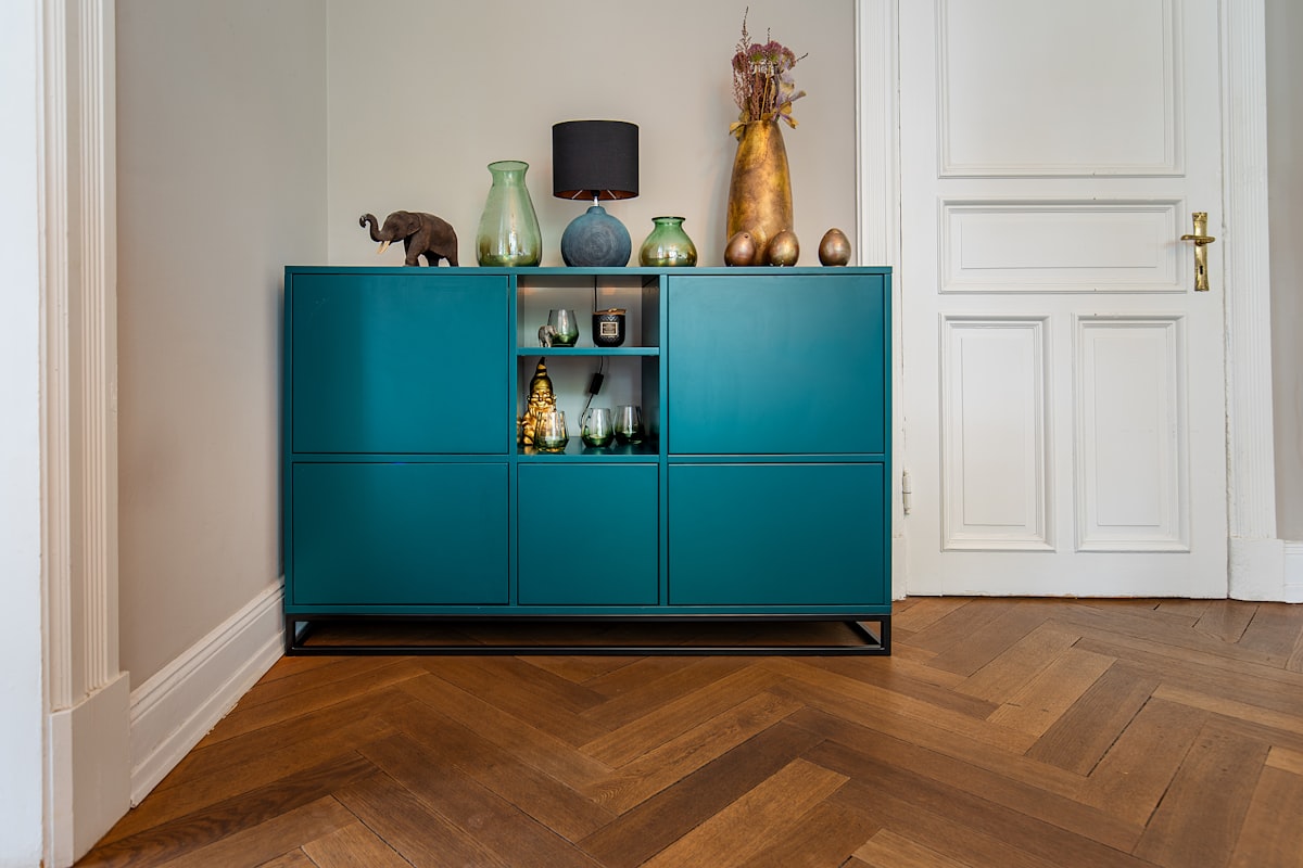 Colored sideboard in an old building with real wood parquet. related to The Ultimate Guide to Buffets and Sideboards