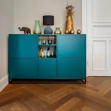 Colored sideboard in an old building with real wood parquet. related to The Ultimate Guide to Buffets and Sideboards