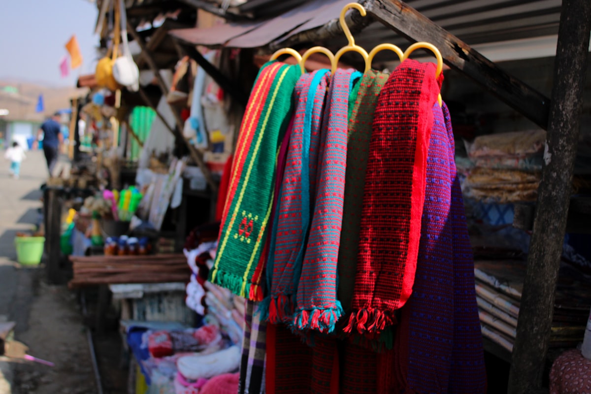 Colorful clothes in a street shop. related to How to Hang Scarf Valances