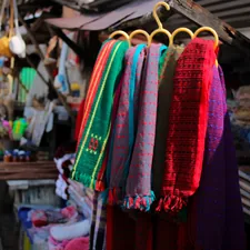 Colorful clothes in a street shop. related to How to Hang Scarf Valances