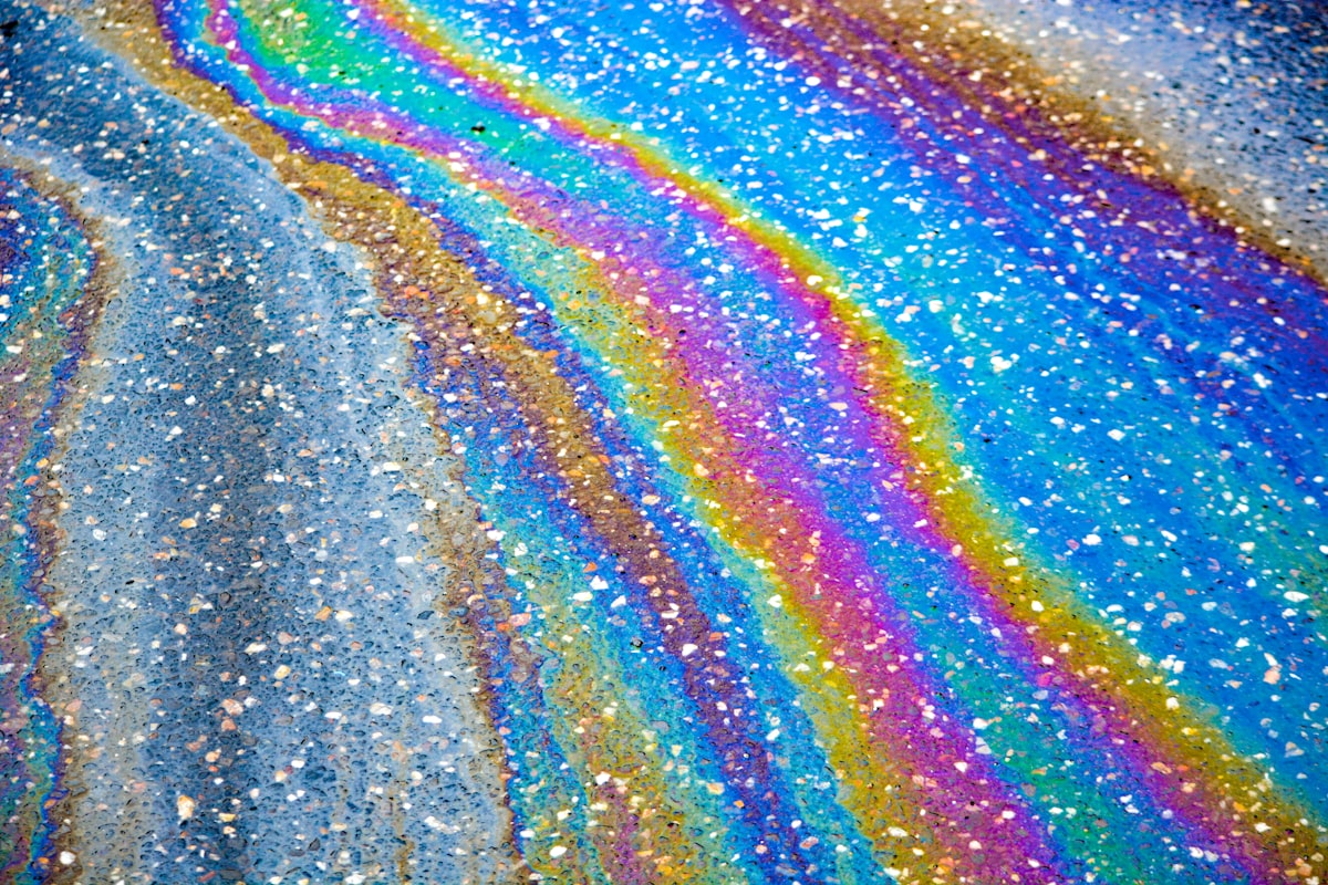 Colorful oil slick on asphalt pavement related to Add Sparkle to Your Bedroom with Glitter Bedding Sets