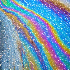 Colorful oil slick on asphalt pavement related to Add Sparkle to Your Bedroom with Glitter Bedding Sets