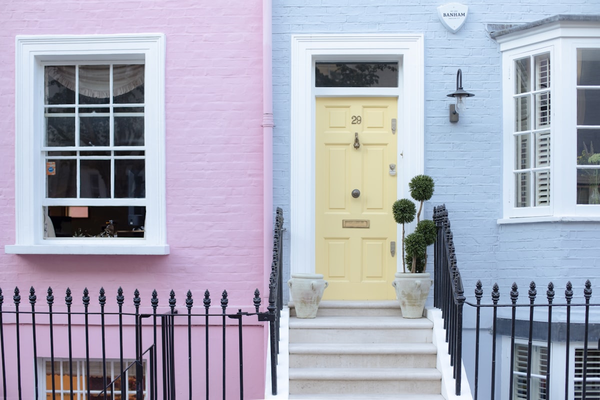 Colorful row houses with a yellow door and steps. related to Discover the Charm of Lancaster Bed and Breakfast